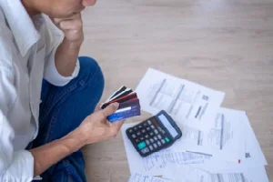 Man with credit cards calculating bills