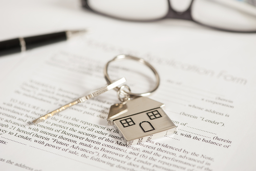 house keychain sitting on top of paperwork