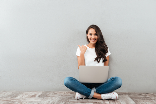 woman sitting smiling using computer