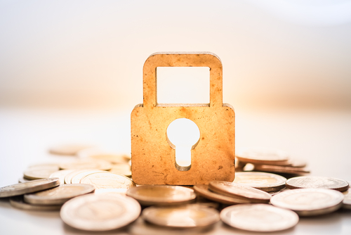 lock sitting on top of stack of coins