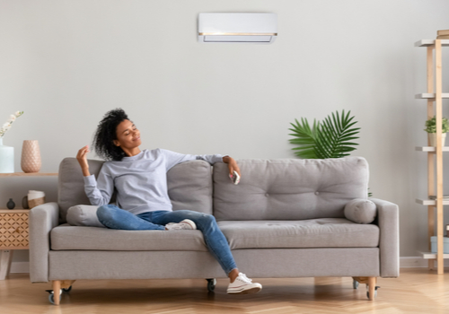 A woman relaxing on her sofa