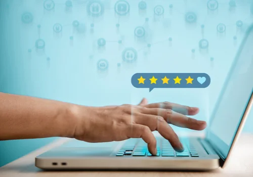 a person a dding a five ster review on their laptop
