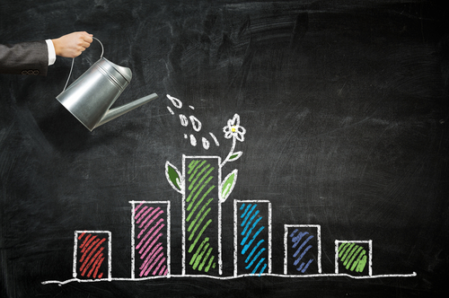 image of arm using container to pour water on a bar graph to symbolize money growth through investing