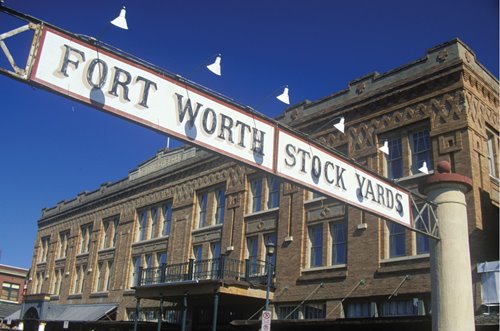 Picture or a building with a sign that reads "Fort Worth" 