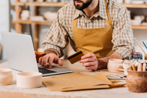 person using credit card at business