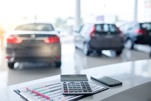 calculator on a desk inside car dealership