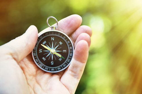 hand holding compass