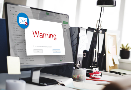 desktop with an open email that displays a warning message