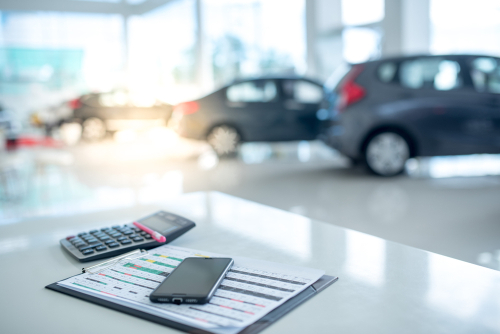 calculator sitting on desk inside car dealership