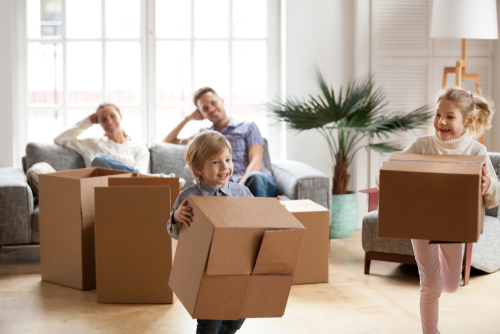 Happy family with moving boxes