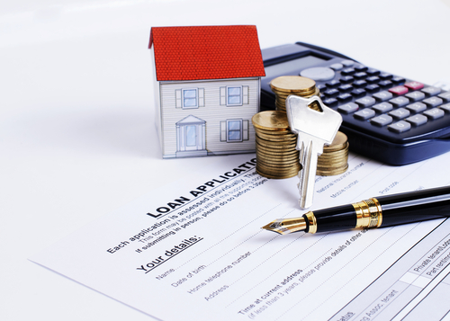 home loan application paperwork and calculator and keys