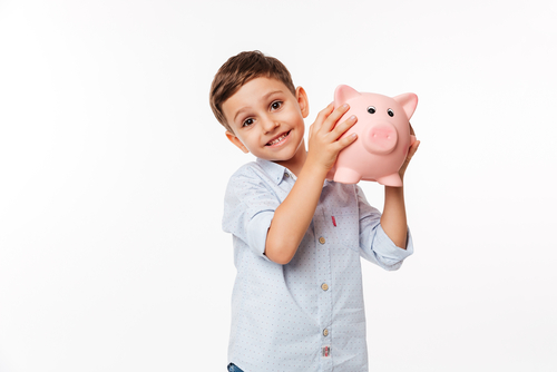 child holding up a piggy bank