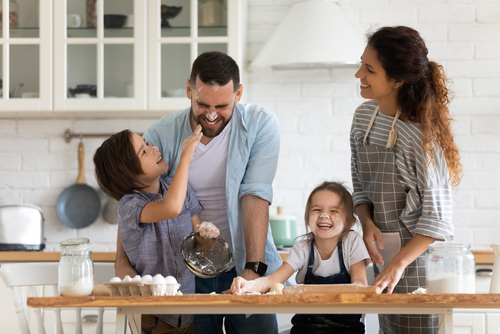 family cooking and playing in kitchen