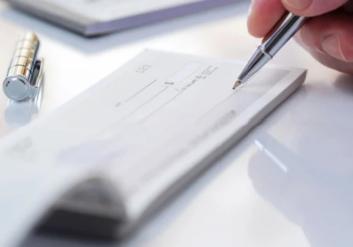a person writing a check