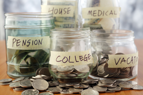 multiple jars of money with each labeled for different things to save money for