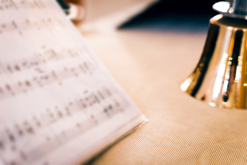 copy of music on a desk with bell