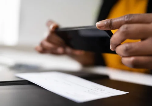 A person taking a pic of a check