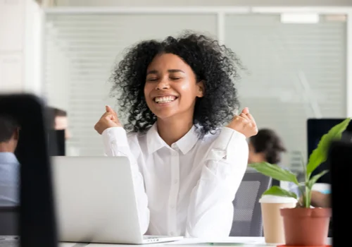 young lady looking at her credit card rewards on her laptop in the office