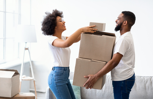 man carrying boxes and woman helping arrange