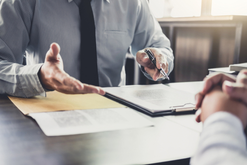 people discussing paperwork on table